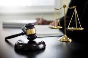 gavel on a desk with a gold scale