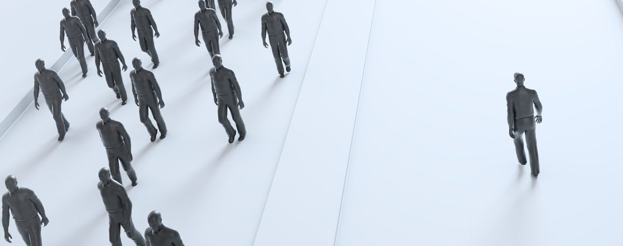 a crowd of individuals walking an opposite path from a lone individual, this symbolizes the stand some executives must make to uphold good c-suite ethics