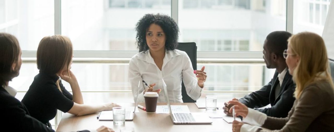 African-American female executive leads diverse group of professionals who appear to be concerned or worried
