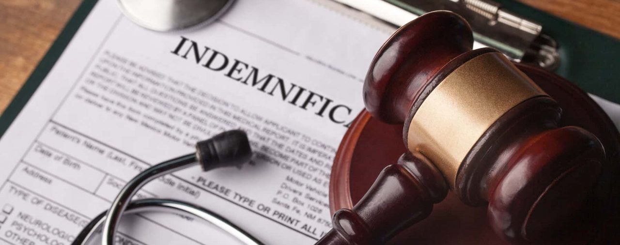 a gavel superimposed on a document showing an indemnification clause physician contract