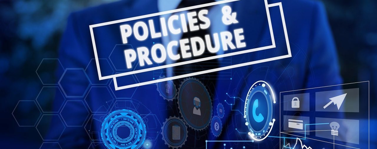 Man holding a design that labels Policies and procedures in blue, what it is and how it works.
