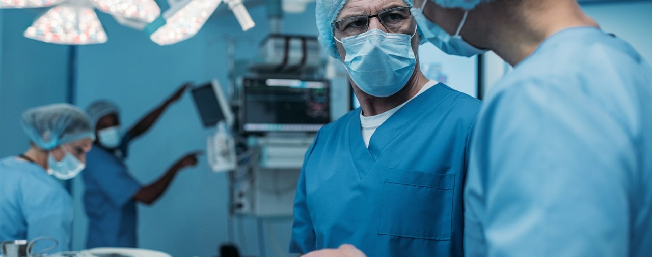 doctors using tablet in surgery room
